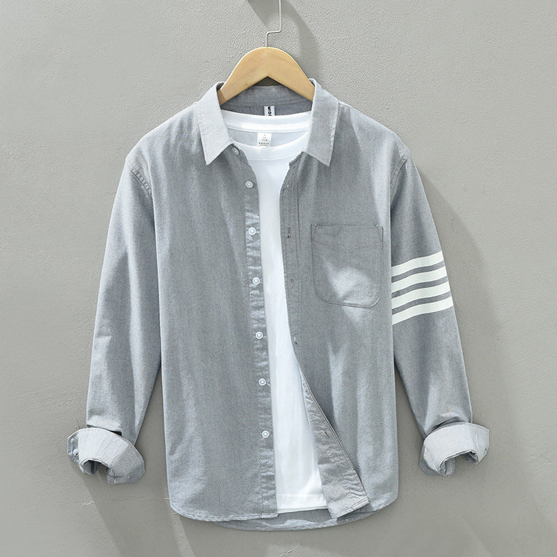 Full view of men's classic striped button-up shirt, showcasing its versatile design.