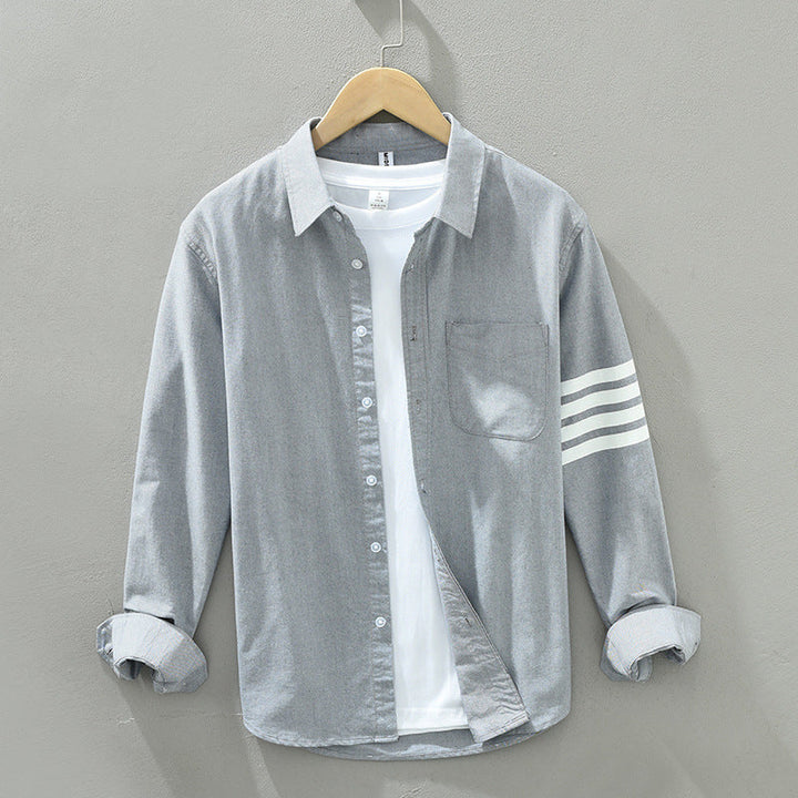 Full view of men's classic striped button-up shirt, showcasing its versatile design.