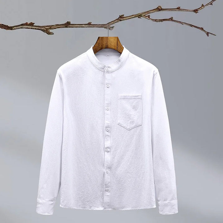 Detailed view of the fabric and buttons on a men's classic long-sleeve tailored fit button-up shirt.