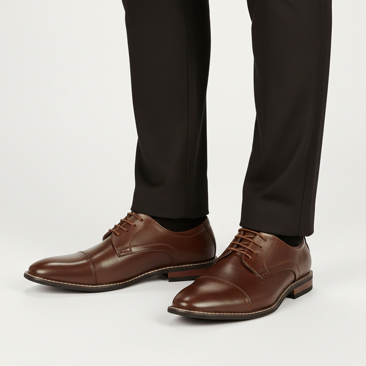 Side profile of men's classic wingtip brogue shoes in rich burgundy, showcasing the oxford lace-up