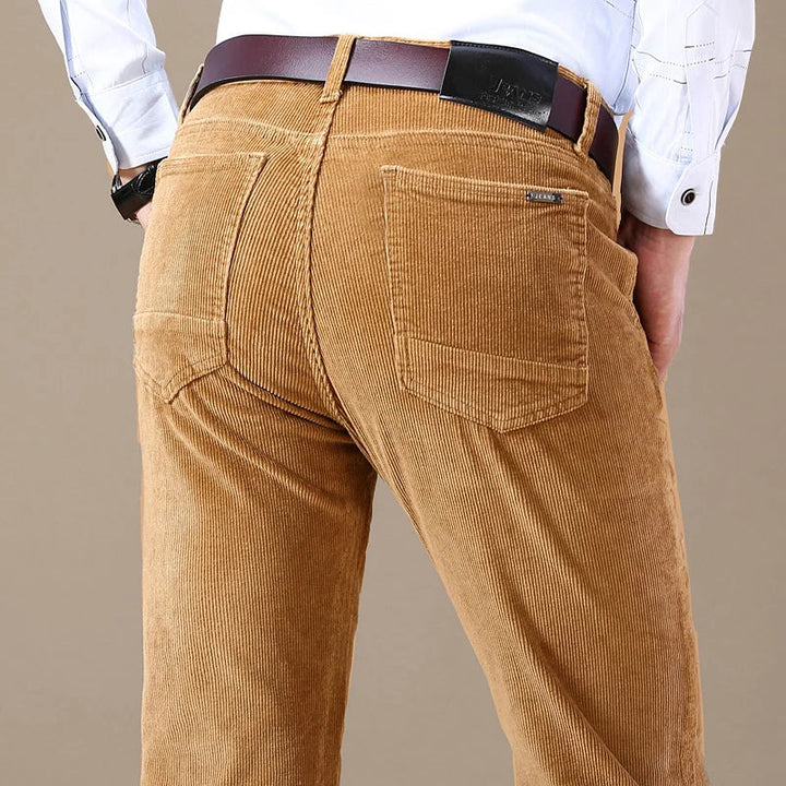 Man wearing dark blue classic textured straight-leg jeans, styled for comfortable everyday fashion.