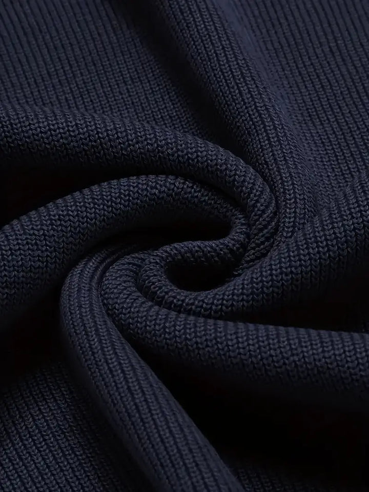Close-up of a men's classic V-neck sweater in soft knit fabric, showcasing its texture and timeless quality.