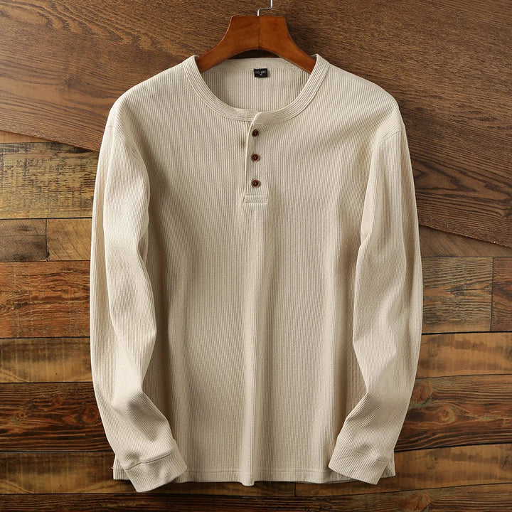Man modeling a comfortable long sleeve waffle knit shirt, perfect for relaxing or casual outings.