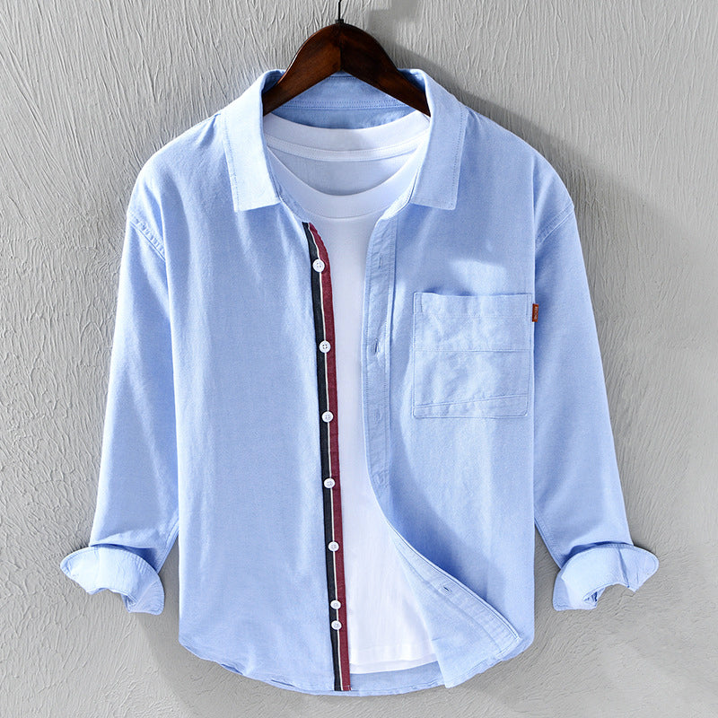 Men's classic white Oxford shirt with unique ribbon trim. Long sleeve button-down, versatile for casual or formal wear.