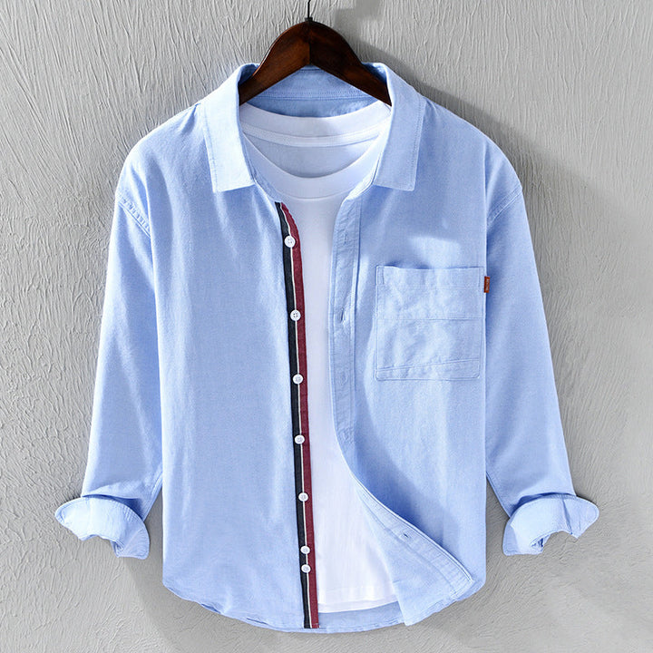 Men's classic white Oxford shirt with unique ribbon trim. Long sleeve button-down, versatile for casual or formal wear.