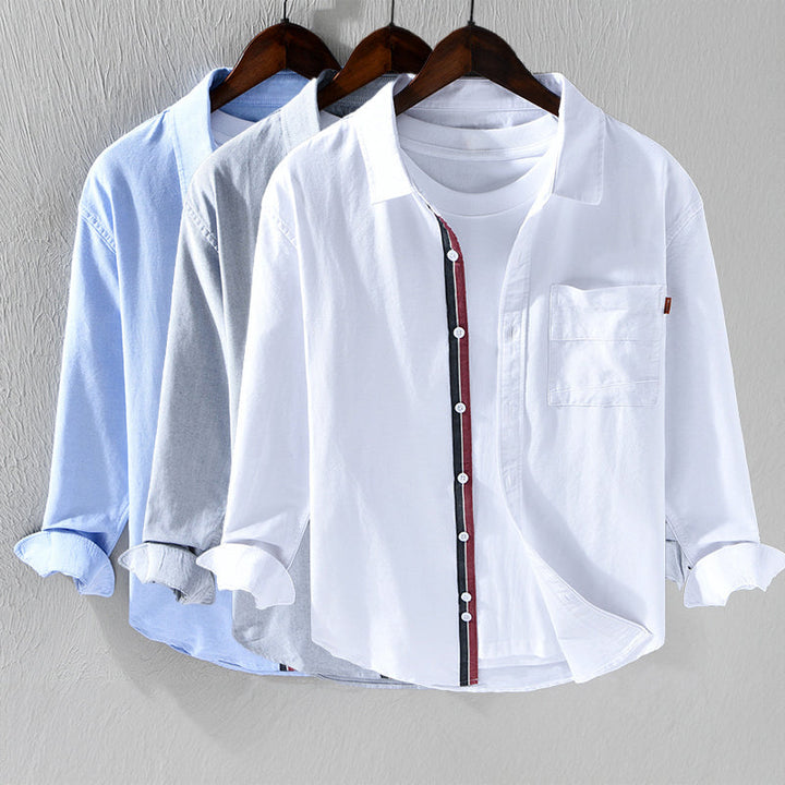 Unique men's Oxford button-down shirt, long sleeve. Showcases distinctive ribbon trim detail. Stylish & versatile.