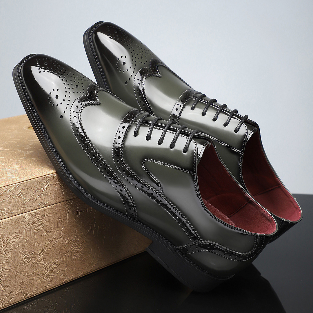 Detail shot of the perforations on men's classic wingtip brogue formal shoes.