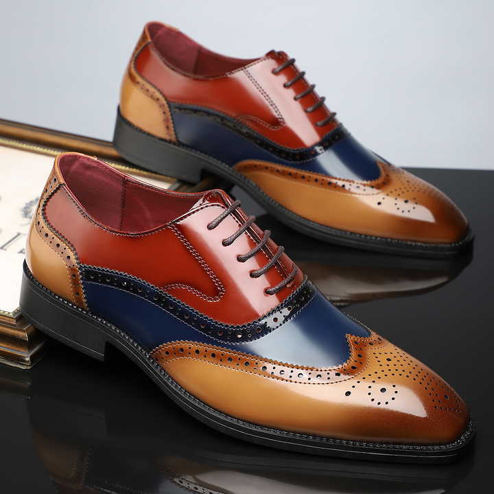 Close-up of intricate wingtip and brogue detailing on men's dress shoes.