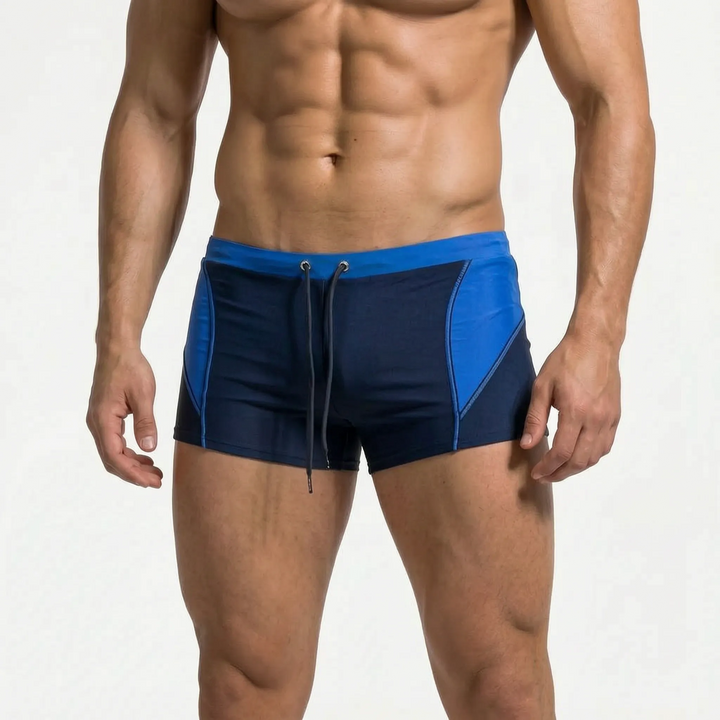 Comfortable men's color block swim trunks with a secure, fitted design for active summer days.
