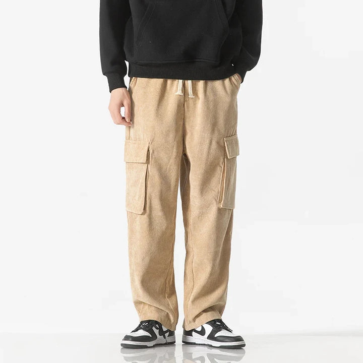 Man wearing comfort fit cargo pants with drawstring, showcasing relaxed style and ease of movement.