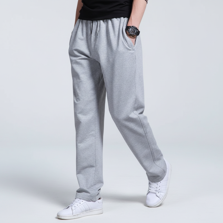 Stack of folded men's comfortable jogger pants in various colors, ready for casual or active use.