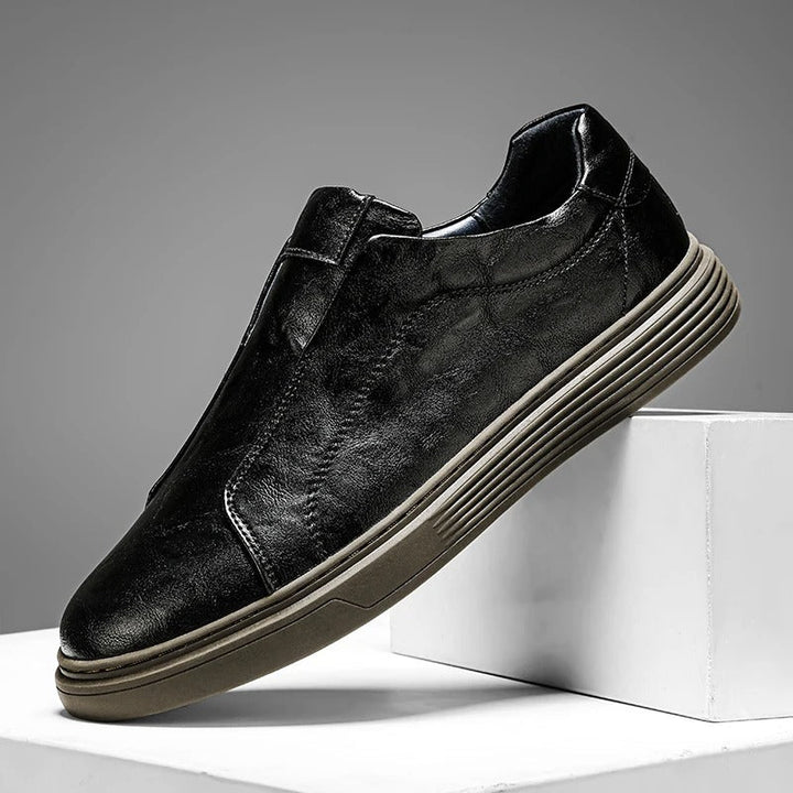 Versatile men's black leather slip-on shoes, great for both dress casual and comfortable daily wear.