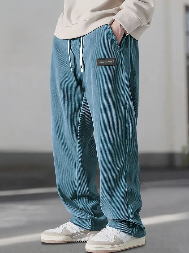 Multi-pocket men's corduroy cargo pants in olive green, showcasing spacious side and utility pockets.