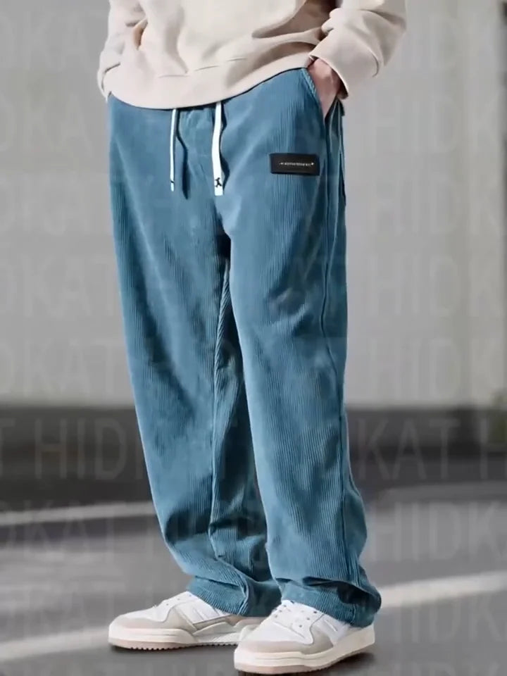 Black men's relaxed fit corduroy cargo trousers, offering comfort and style for casual wear & street fashion.