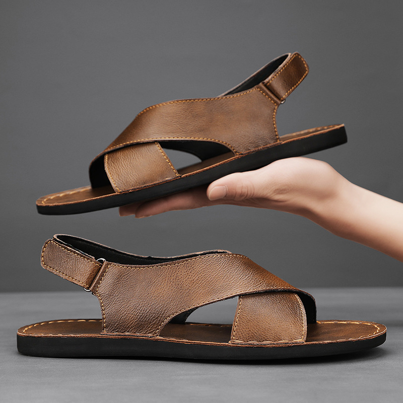 Stylish men's open-toe cross-wrap slip-on sandals with a flat sole, great for summer comfort & beach.