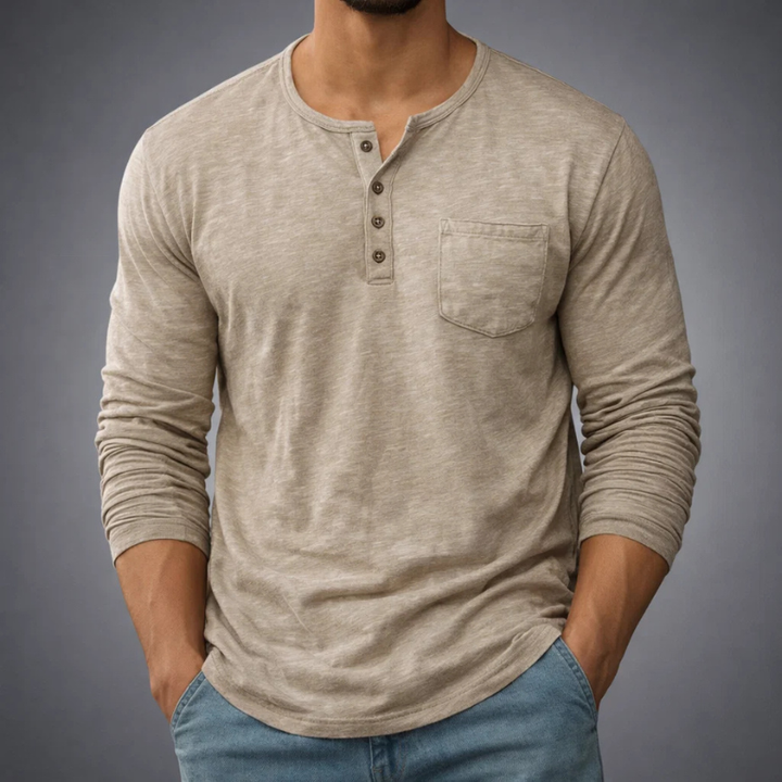 Model wearing a versatile men's long sleeve henley top, ideal for comfortable casual wear & layering.