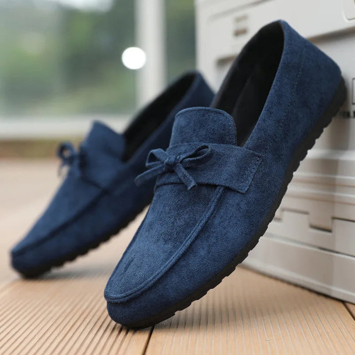 Top-down shot of comfortable men's bow-detailed slip-on shoes, ideal for a refined casual style.