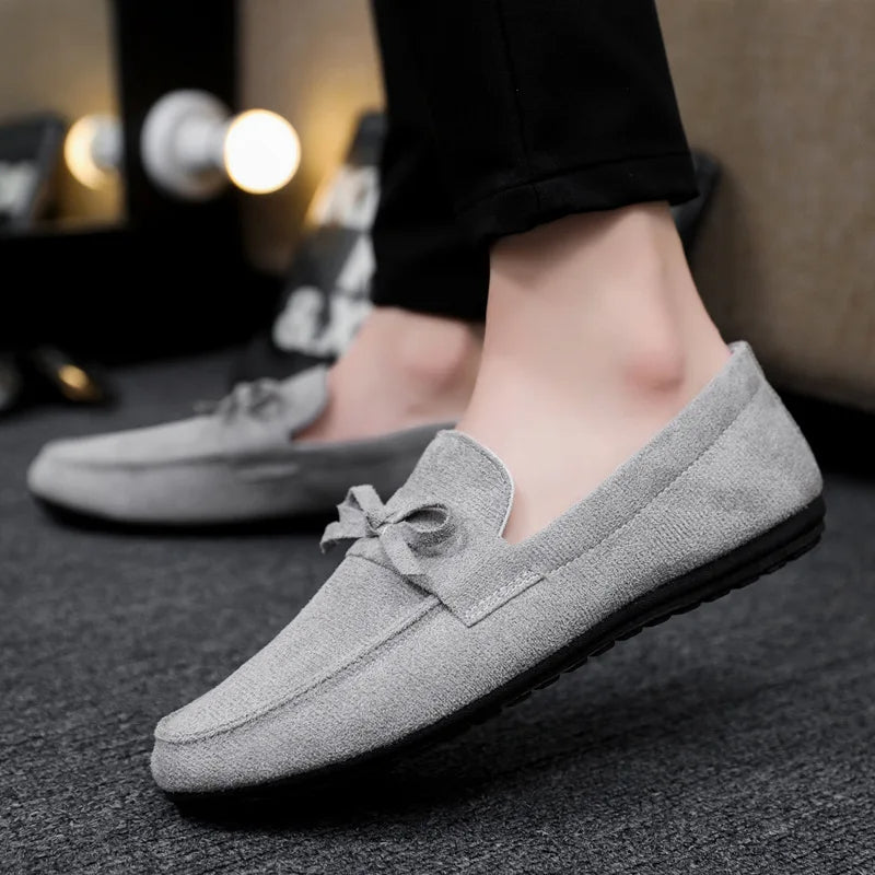 Dress-casual men's slip-on loafers with a modern bow, offering versatility and easy wear.