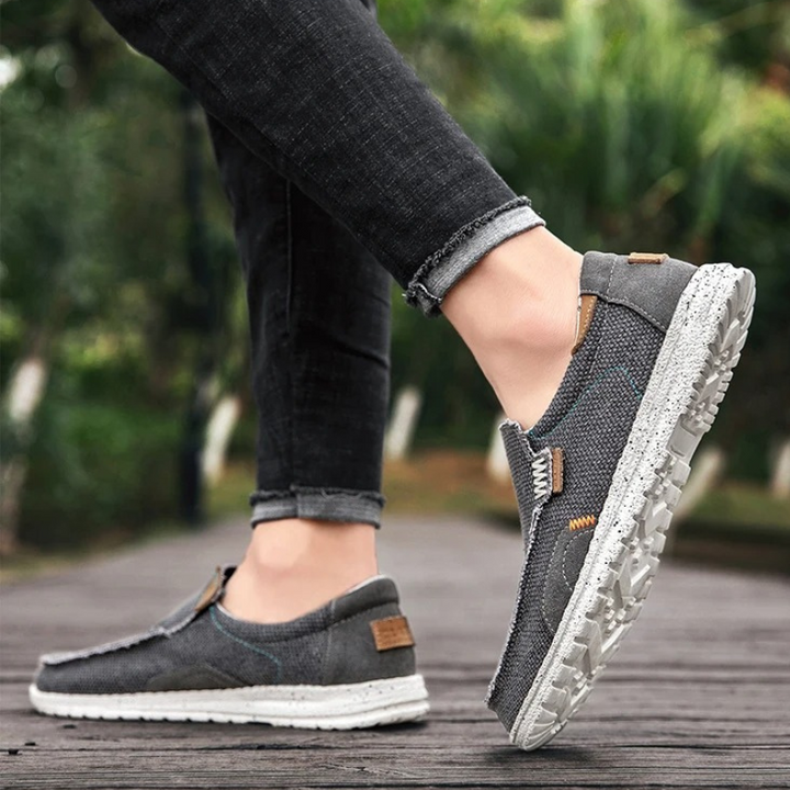 Side view of men's comfortable slip-on shoes with a durable sole, perfect for walking.