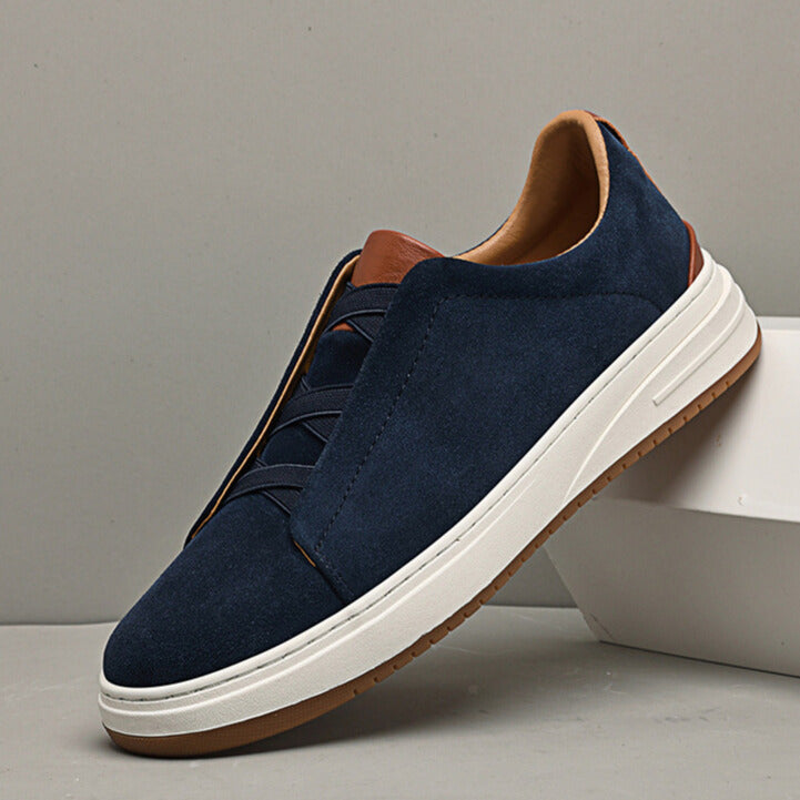 Blue men's slip-on sneakers, offering comfort & casual style for walking.
