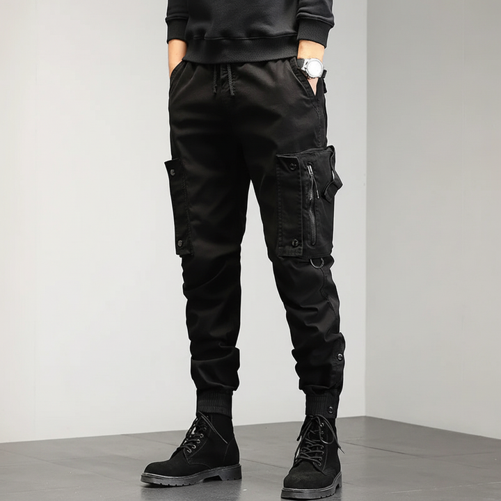 Close-up of men's utility cargo pants fabric, showing stretch material and pocket detail