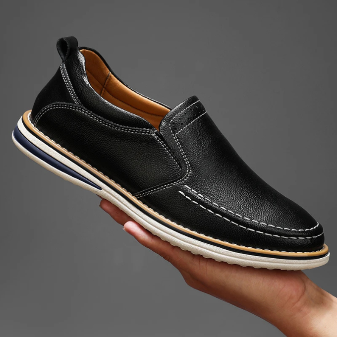 Underside view of men's Cooper Mocs loafers, detailing durable sole & grip for comfort & everyday wear.