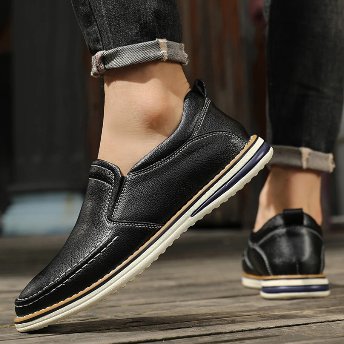 Man walking in Cooper Mocs loafers, emphasizing comfortable & stylish slip-on shoes for everyday activities.