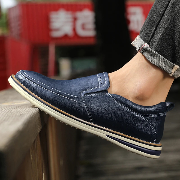 Side profile of men's Cooper Mocs loafers, highlighting slip-on design & modern classic silhouette.