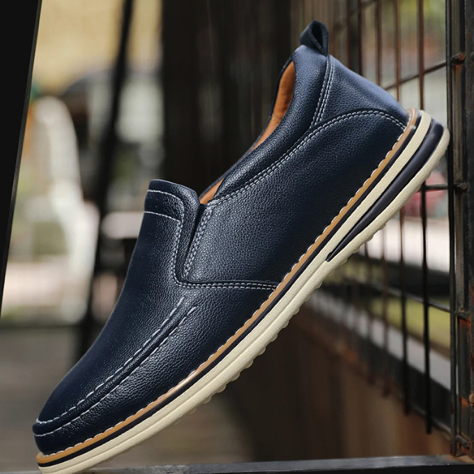 Man wearing Cooper Mocs loafers, demonstrating smart casual style & comfortable fit for standing. Versatile footwear.