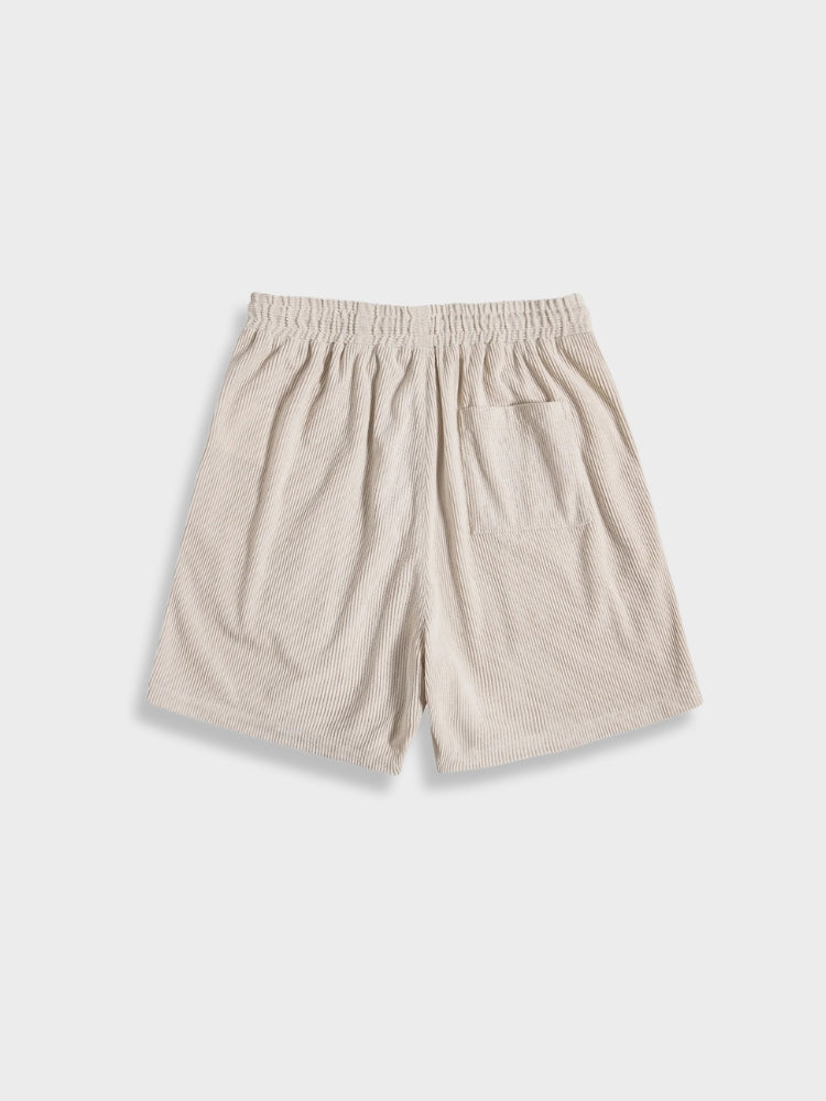 Men enjoying a relaxed summer day in a breathable corduroy shirt and shorts set.