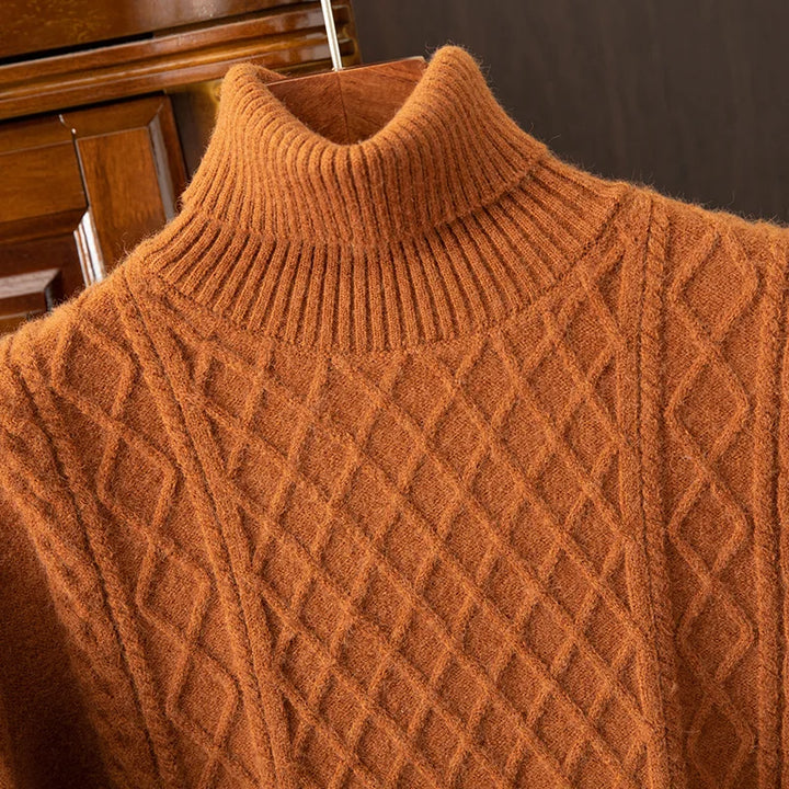 Man wearing a cozy diamond cable knit turtleneck sweater, a warm men's apparel item for winter.