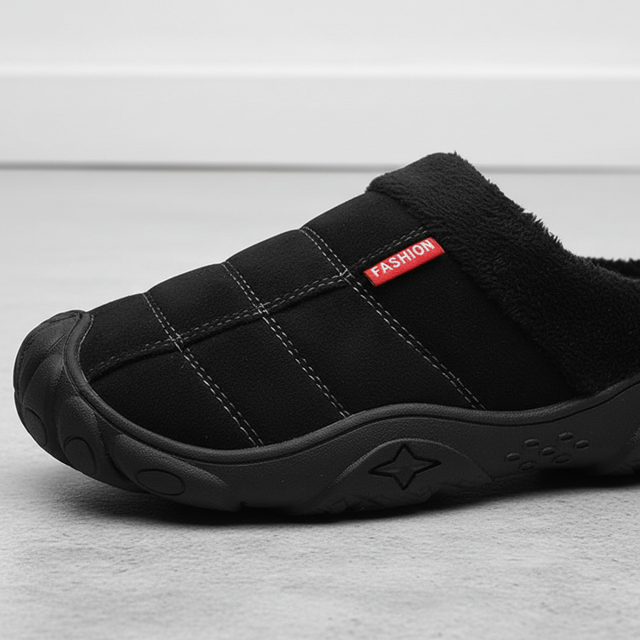 Pair of men's comfortable indoor slippers, fleece-lined in black, ideal for cozy winter evenings