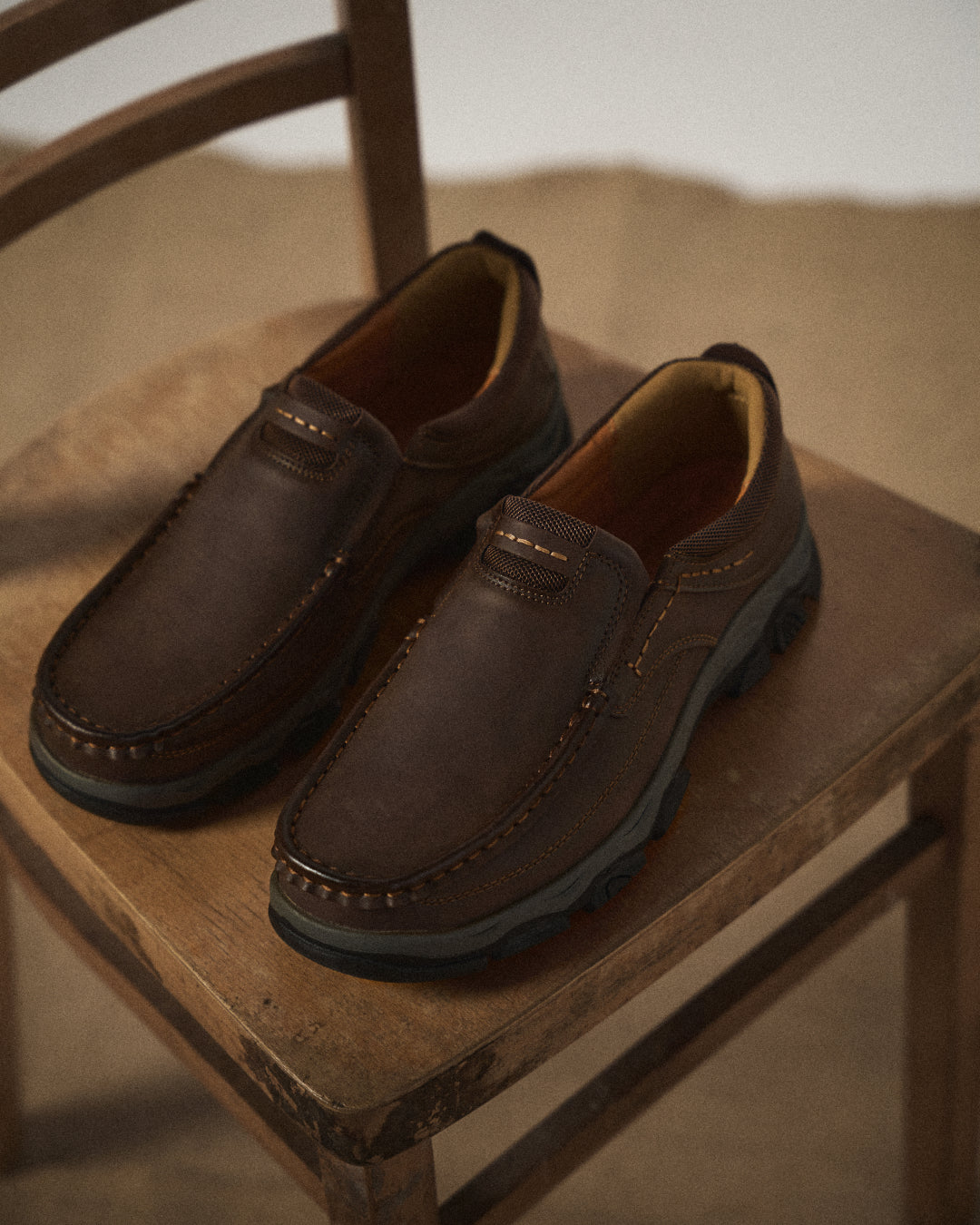Side view of men's brown Dakota slip-on loafers, showing comfortable, durable design.