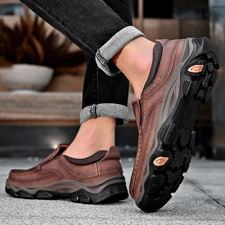Pair of Men's Dakota brown slip-on loafers, comfortable & durable for daily casual wear.