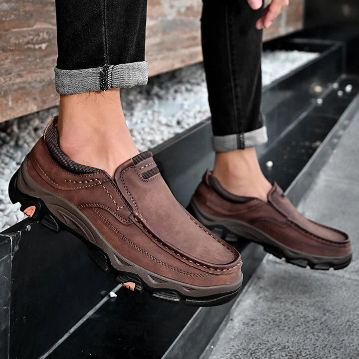 Pair of Men's Dakota black slip-on loafers, versatile & durable for men's casual style.
