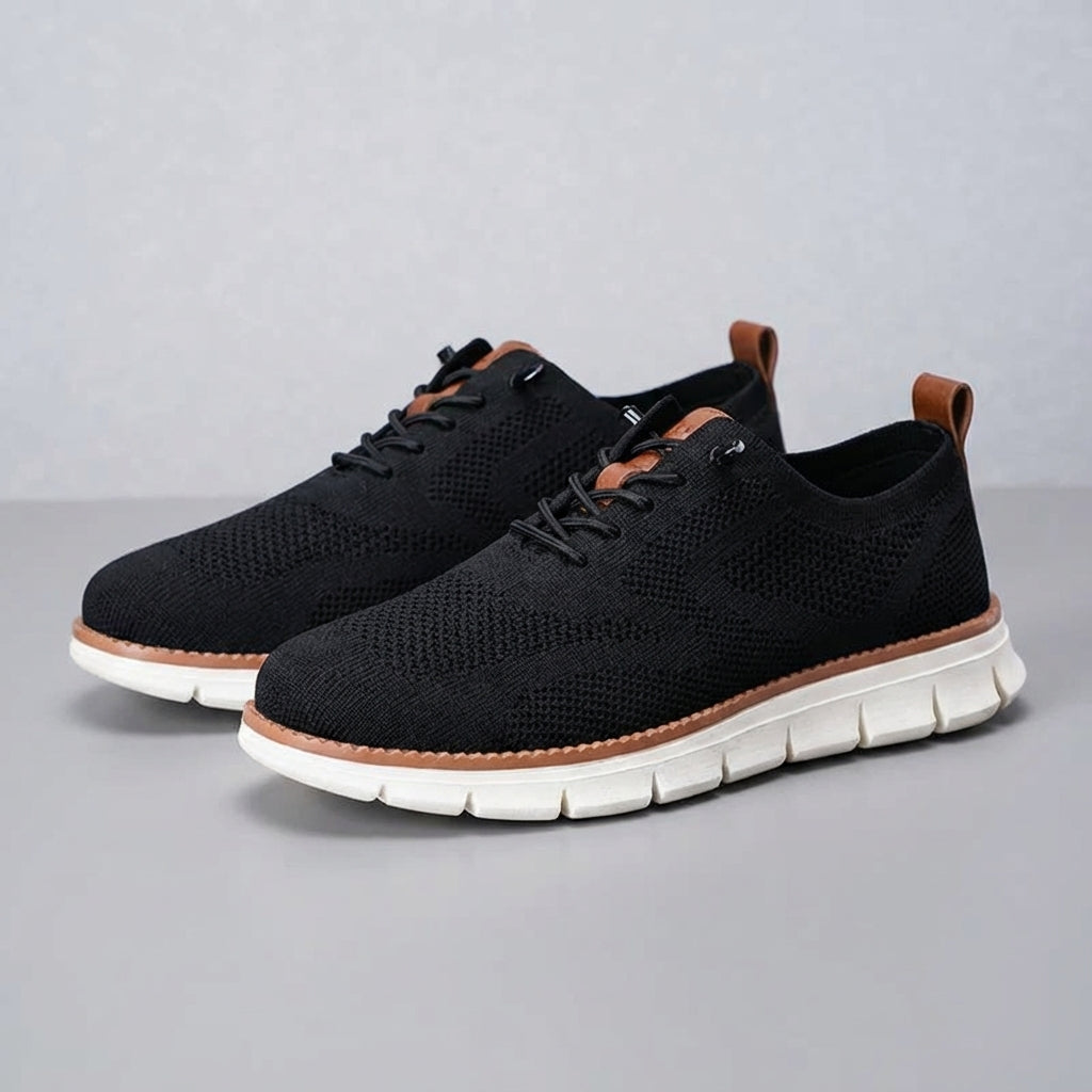 Pair of black men's Damon breathable trainers on a white background, emphasizing athletic design.