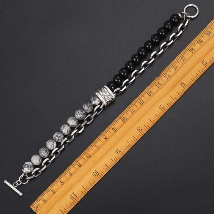 Close-up of men's protective jasper bead bracelet, showcasing unique stone patterns