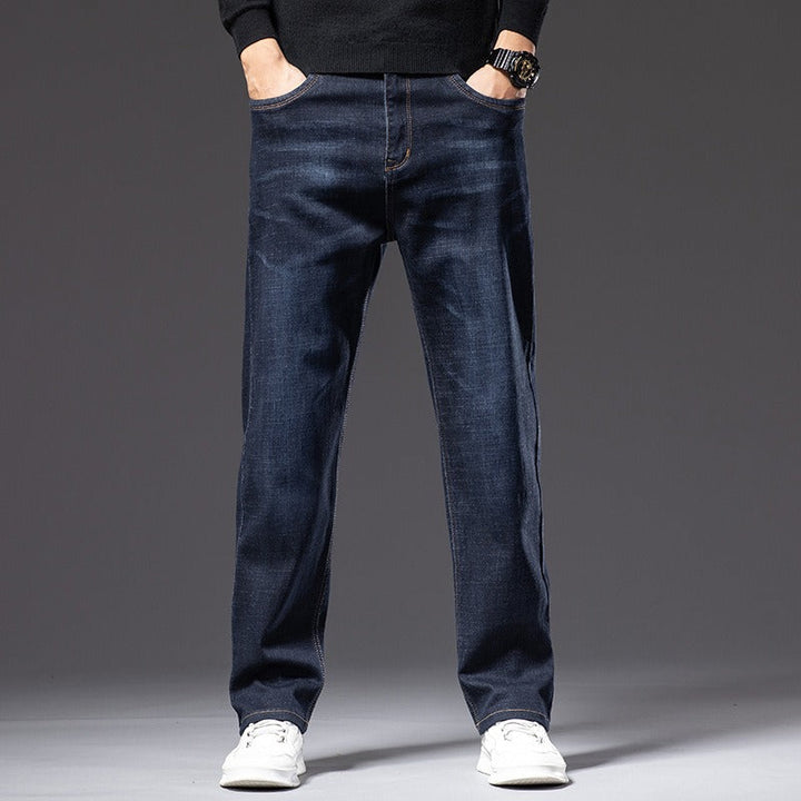 Modern men's stretch denim jeans, available in blue, black, & gray for comfort & style.