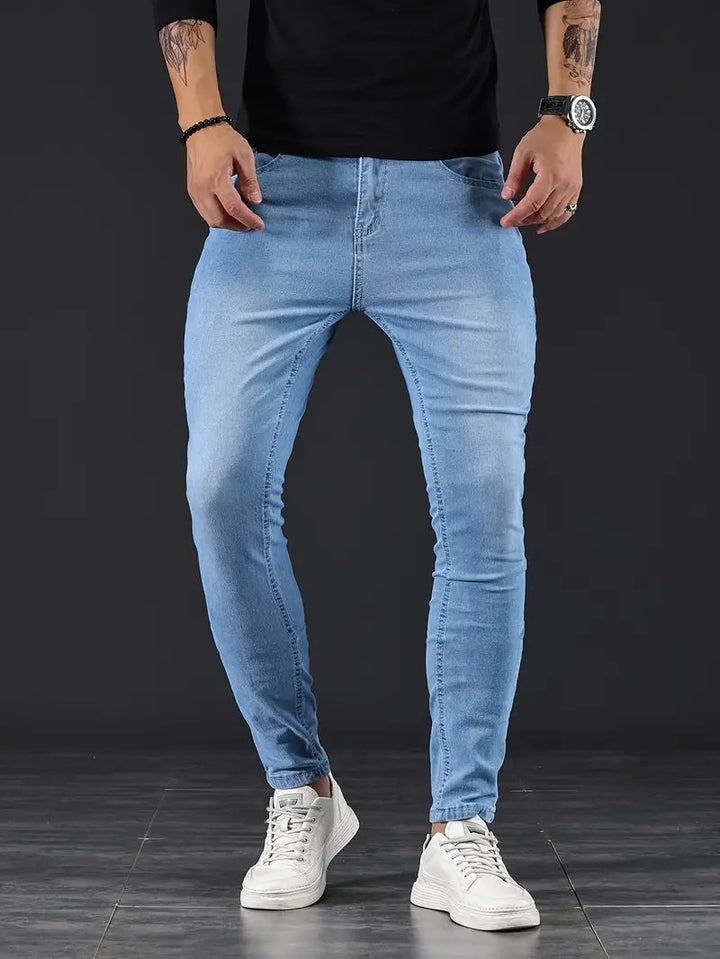 Light wash men's tapered fit stretch jeans, ideal for modern comfort & everyday style.