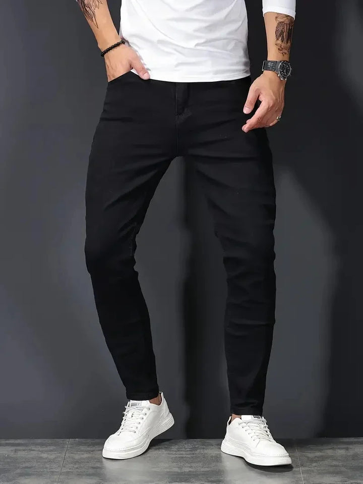 Modern men's dark wash stretch jeans, slim fit for ultimate comfort & flexible wear.