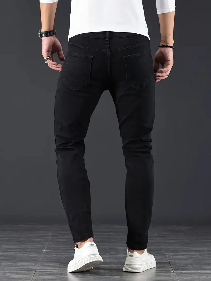 Flexible black slim fit men's jeans, perfect for modern casual style & everyday comfort.