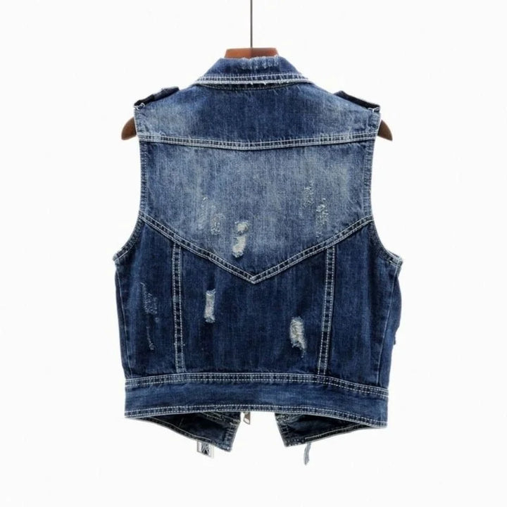 Rugged men's distressed black denim vest, sleeveless jacket, ideal for streetwear and casual looks.
