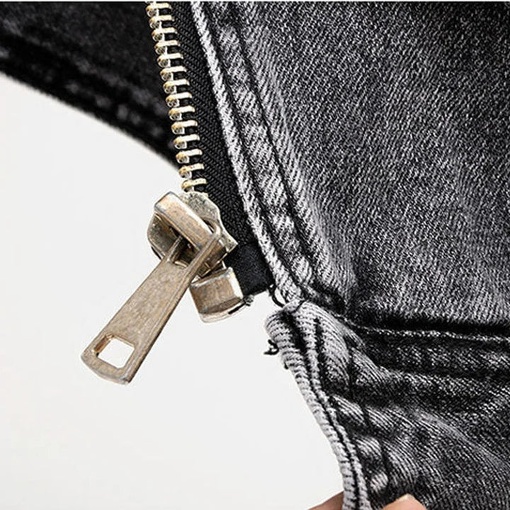 Stylish men's distressed denim moto vest, an asymmetric zip sleeveless jacket for streetwear and biker fashion.