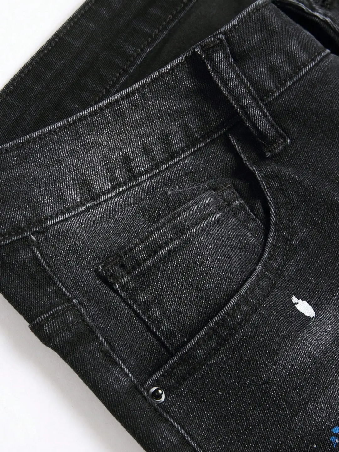 Grey men's distressed tapered denim jeans, featuring strategic rips and a flattering modern street wear fit.