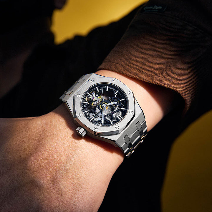 Dominus men's stainless steel watch on wrist, a confident, bold statement timepiece accessory.