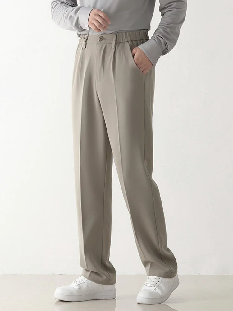 Man wearing stylish draped formal trousers, ideal for business or smart casual outfits. Comfortable men's dress pants.