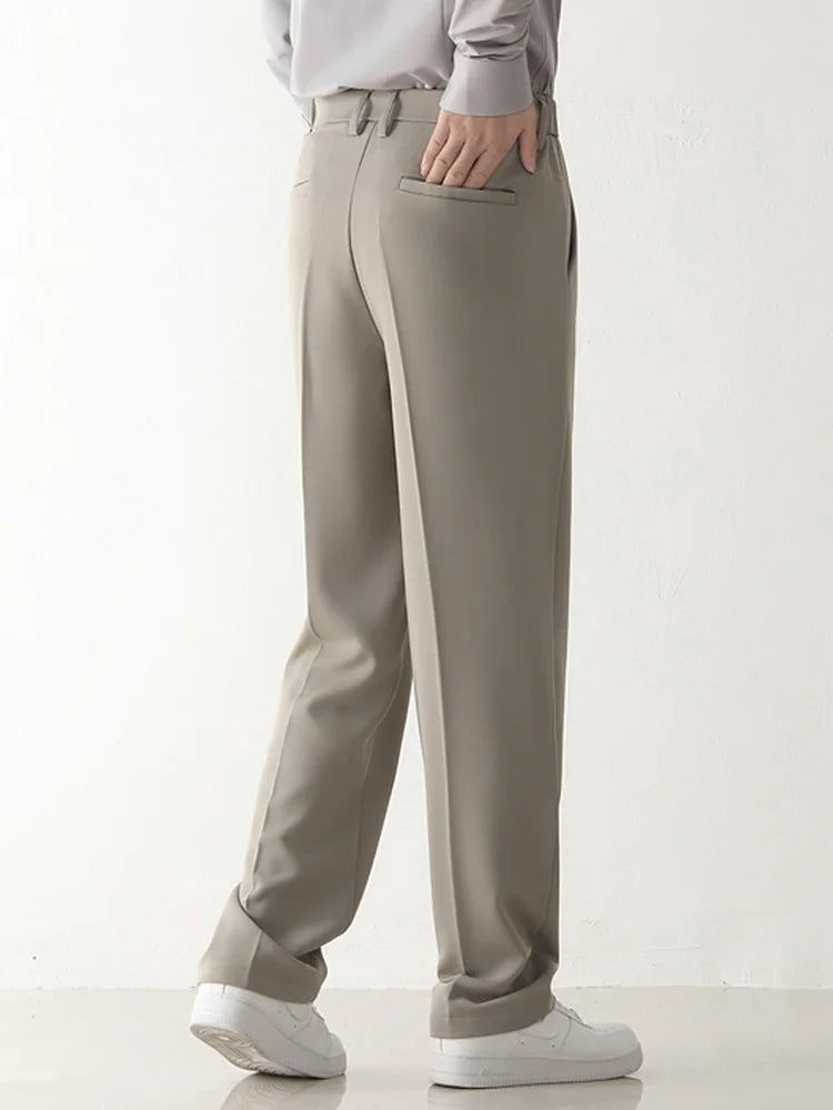 Texture of comfortable polyester blend fabric on men's draped formal trousers. High-quality smart casual pants.
