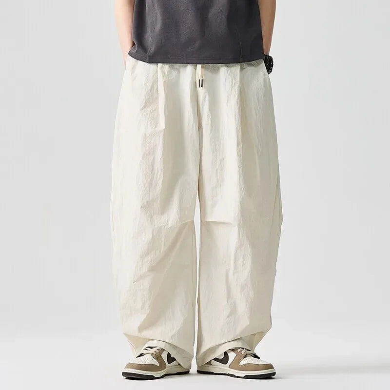 Modern men's Driftline streetwear pants. Relaxed fit and drawstring waist for a stylish, comfortable look.