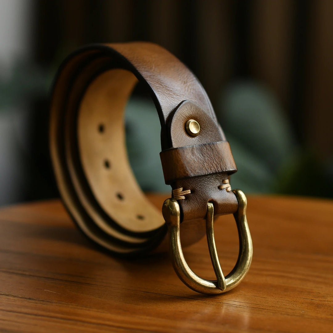 Classic brown men's cowhide leather belt with polished buckle. Durable genuine leather accessory.