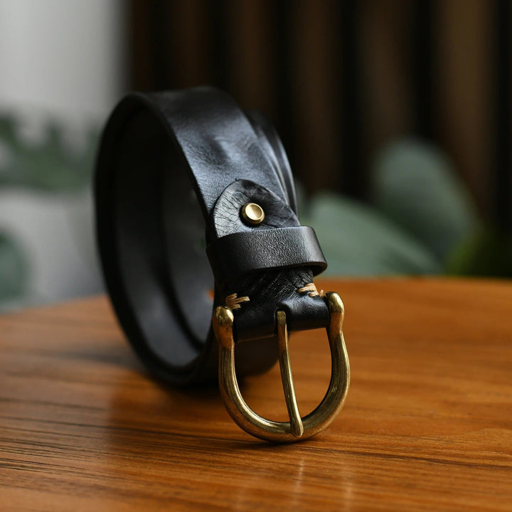 Dark brown durable men's cowhide leather belt. A genuine leather accessory with polished buckle.